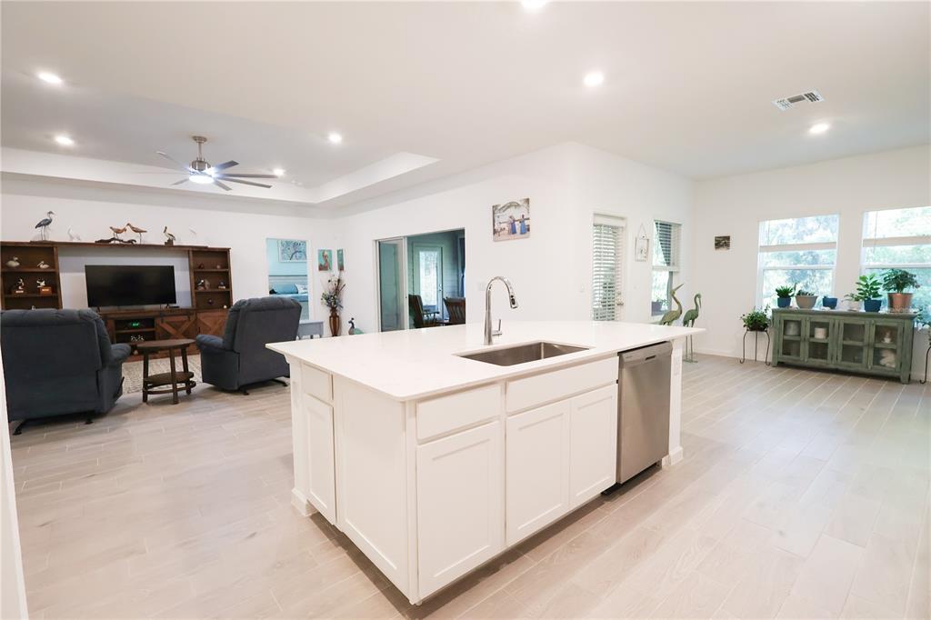 19511 Southwest 77th Loop Dunnellon, FL 34432 - Photo 8 of 27 a large white kitchen with a large island in the center