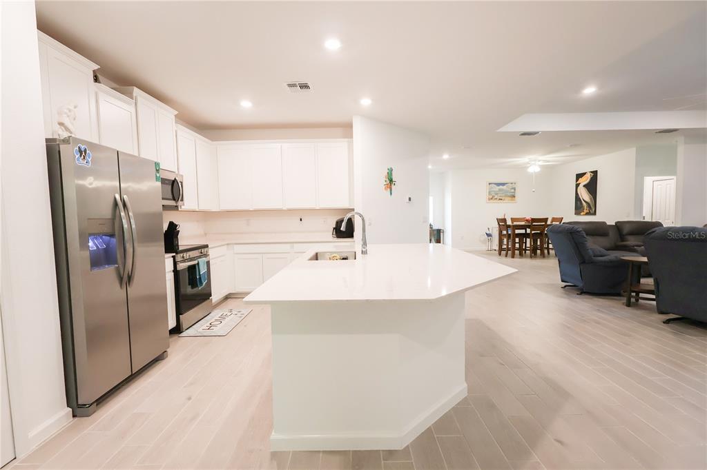 19511 Southwest 77th Loop Dunnellon, FL 34432 - Photo 10 of 27 a large kitchen with stainless steel appliances a refrigerator and a refrigerator