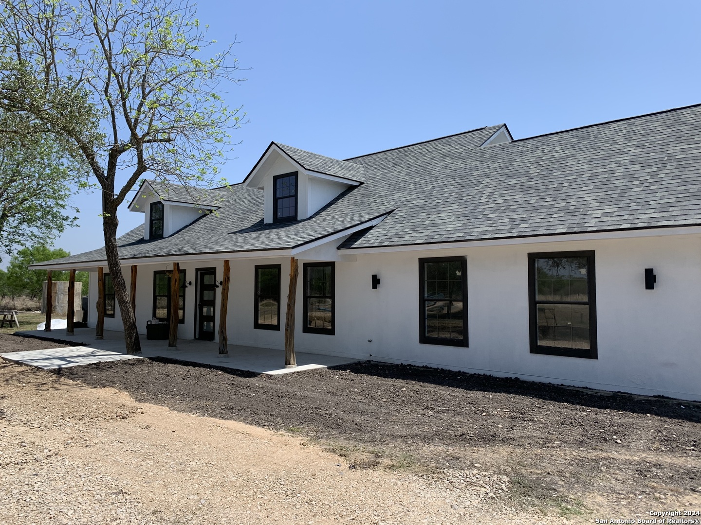 210 County Road 4643 Hondo, TX 78861 - Photo 2 of 12 a front view of a house with a yard