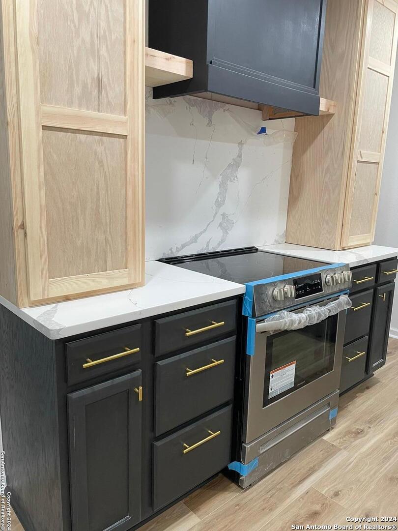 210 County Road 4643 Hondo, TX 78861 - Photo 4 of 12 a kitchen with granite countertop a stove and a sink