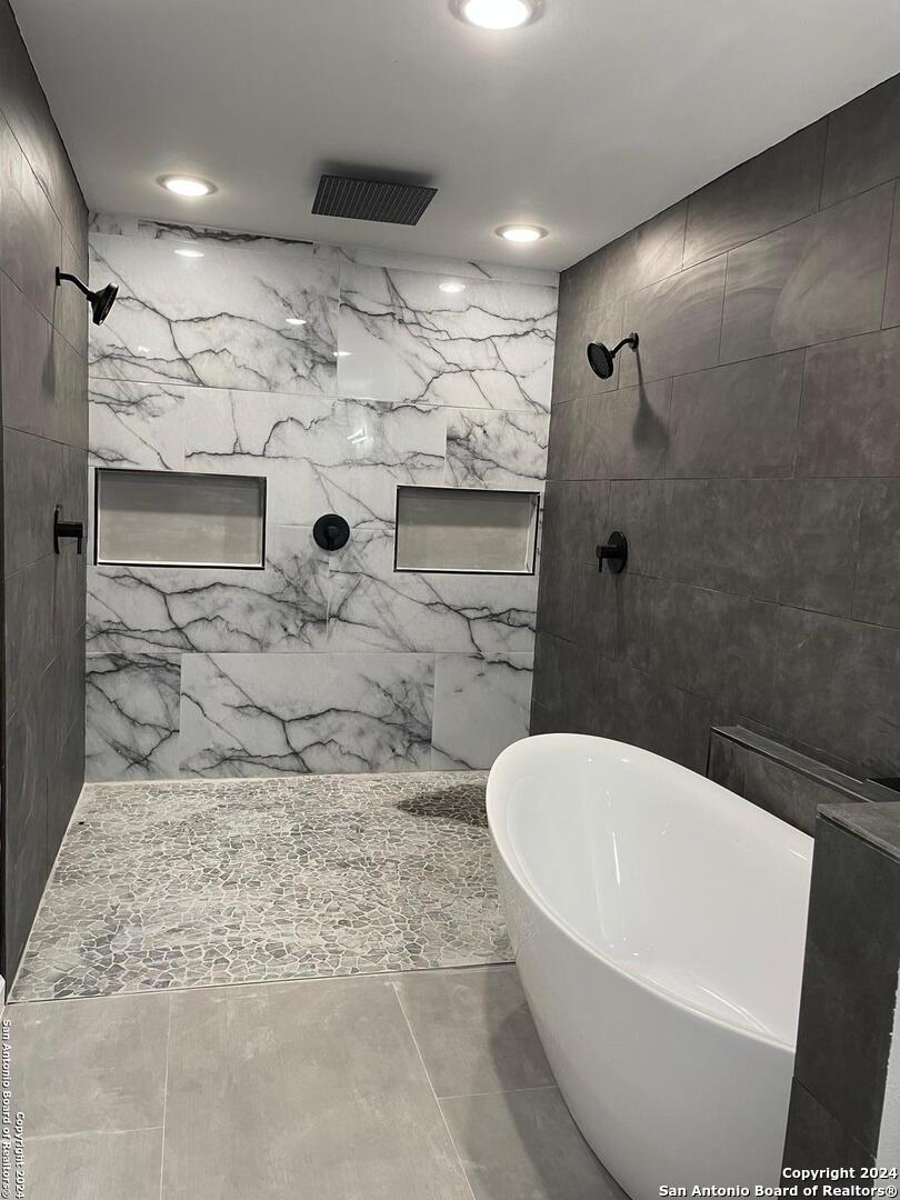 210 County Road 4643 Hondo, TX 78861 - Photo 6 of 12 a bathroom with a bathtub and shower