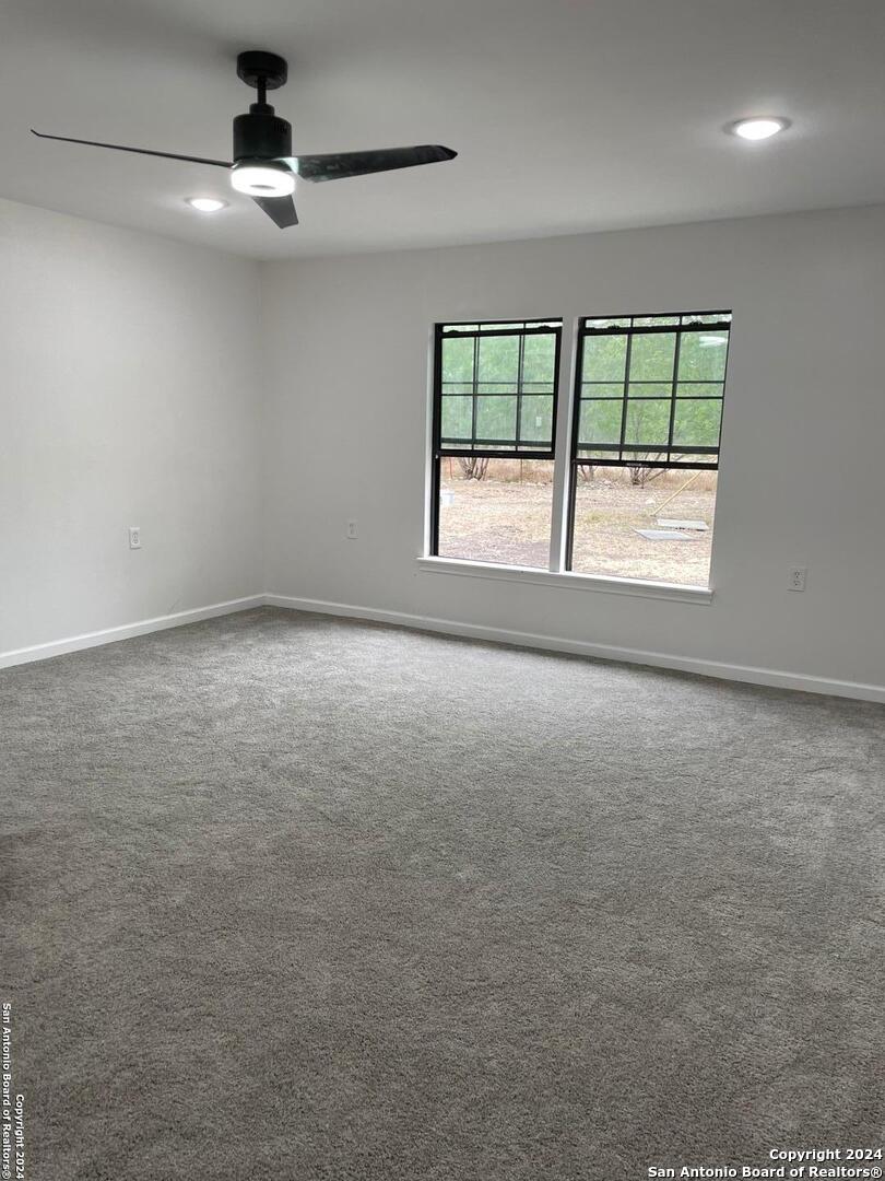 210 County Road 4643 Hondo, TX 78861 - Photo 9 of 12 a view of an empty room with a window