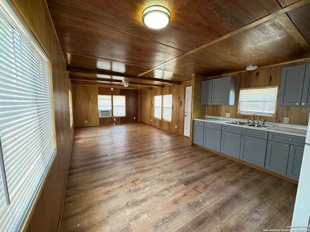 a view of a kitchen with a sink and cabinets