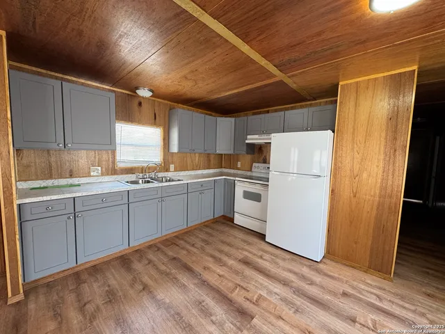 a kitchen with white cabinets and white appliances