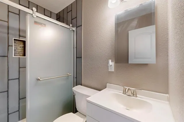 a bathroom with a shower and a toilet