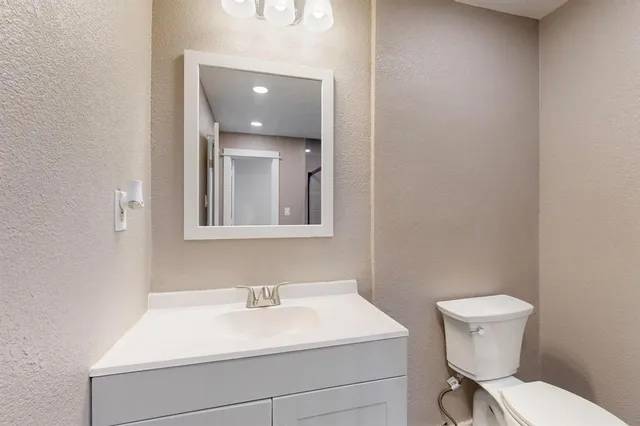 a bathroom with a sink vanity and a mirror