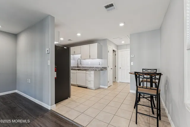 a kitchen with a cabinets and chairs
