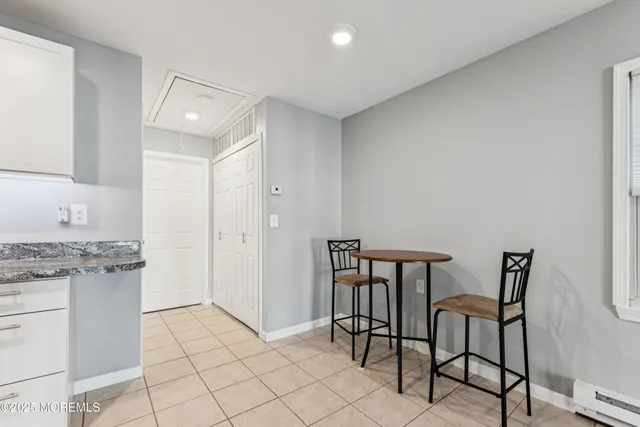 a view of a kitchen with furniture and wooden floor