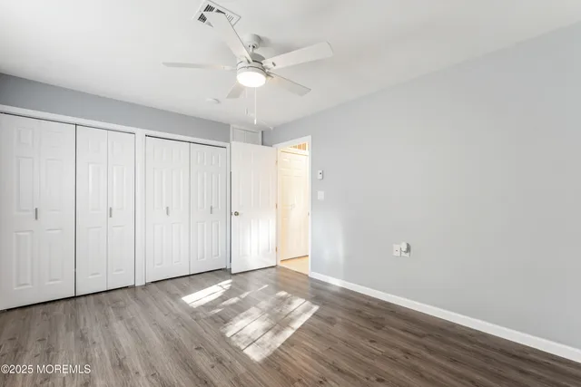 a view of a livingroom with wooden floor and white walls