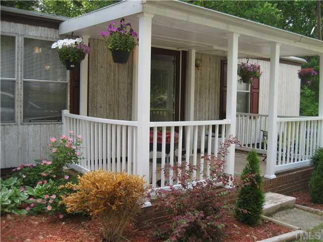7500 Rock Service Station Road Raleigh, NC 27603 - Photo 3 of 21 Another view of the porch with beautiful landscaping.