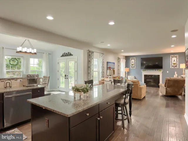 a kitchen with sink refrigerator and couches