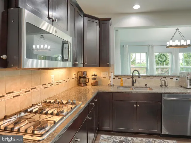 a kitchen with a sink and a stove top oven