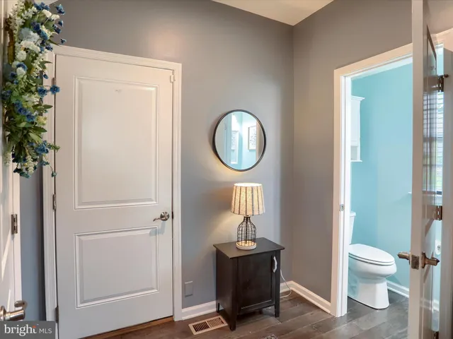 a bathroom with a toilet a sink and a mirror