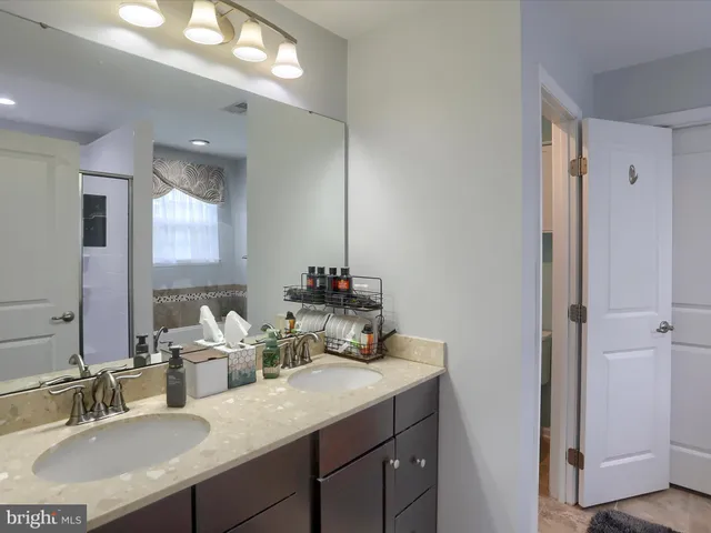 a bathroom with a sink vanity granite and a mirror