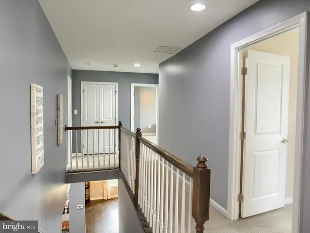 a view of a hallway with windows and stairs