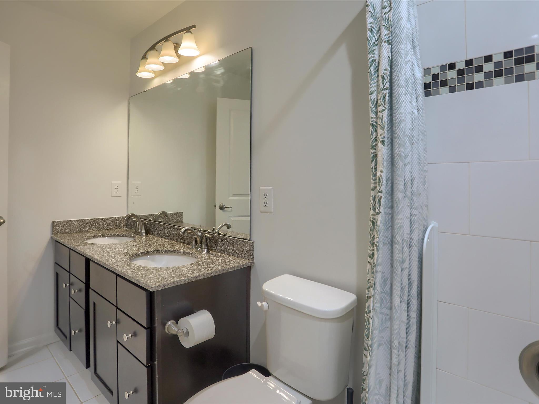 3930 Seattle Slew Drive Harrisburg, PA 17112 - Photo 27 of 48 a bathroom with a granite countertop sink toilet and shower