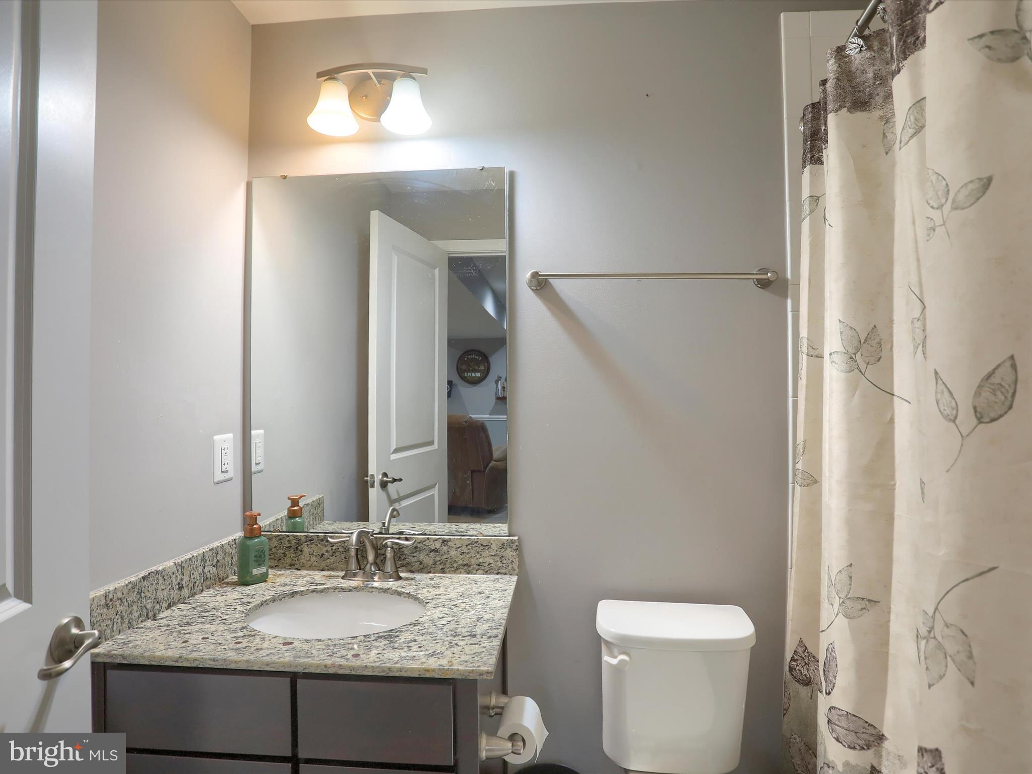 3930 Seattle Slew Drive Harrisburg, PA 17112 - Photo 35 of 48 a bathroom with a granite countertop sink and a mirror