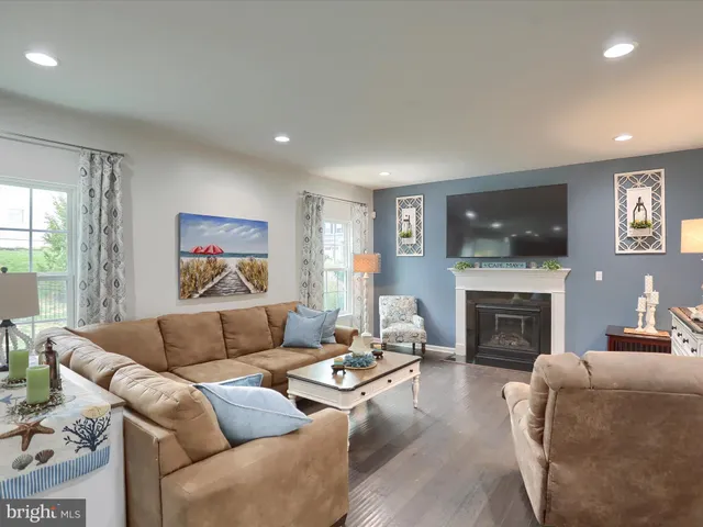 a living room with furniture flat screen tv and a fireplace