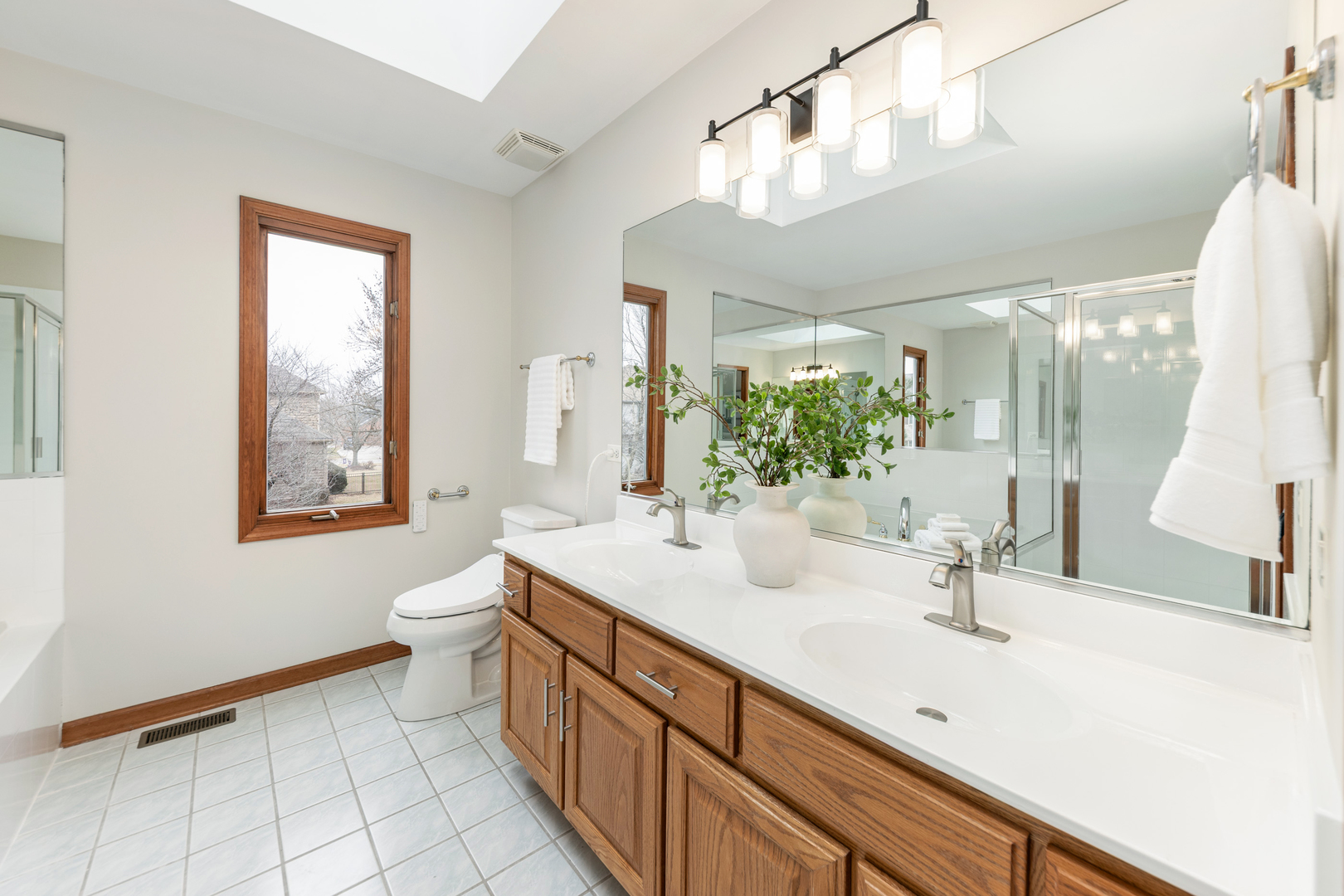 2703 Wait Road Naperville, IL 60564 - Photo 26 of 35 a bathroom with a sink and a large mirror