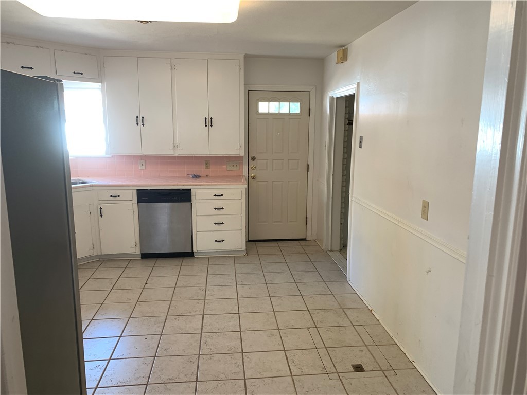 606 Hopper Drive Corpus Christi, TX 78411 - Photo 4 of 8 a room view with a wooden cabinets and utility room