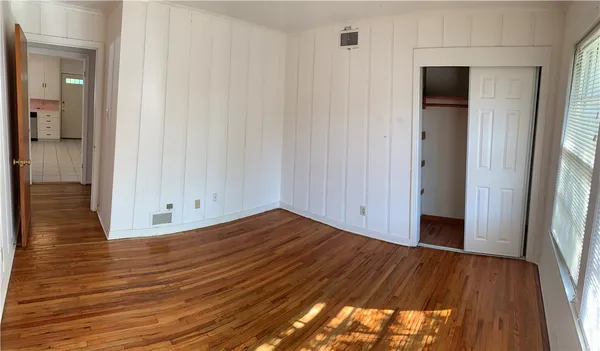 a view of a room with wooden floor and brick wall