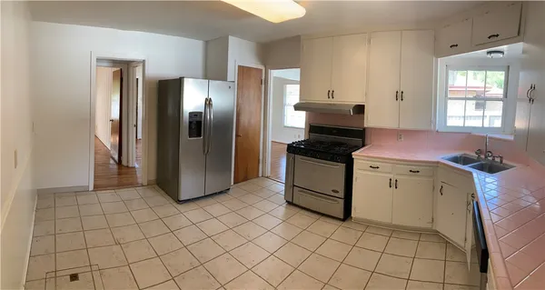 a kitchen with cabinets and steel stainless steel appliances