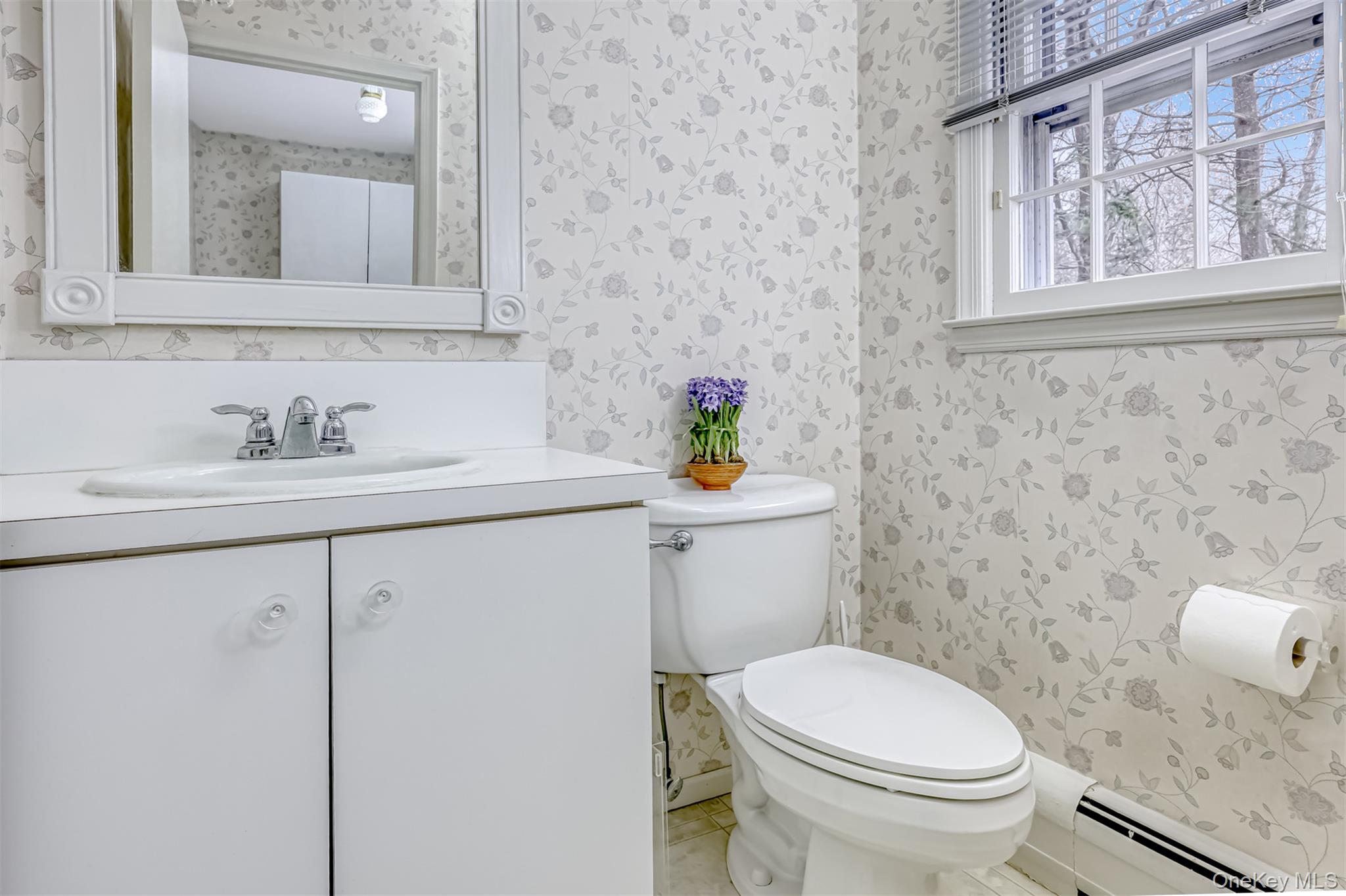 16 Kings Gate Road Suffern, NY 10901 - Photo 11 of 21 a bathroom with a sink a toilet and a mirror