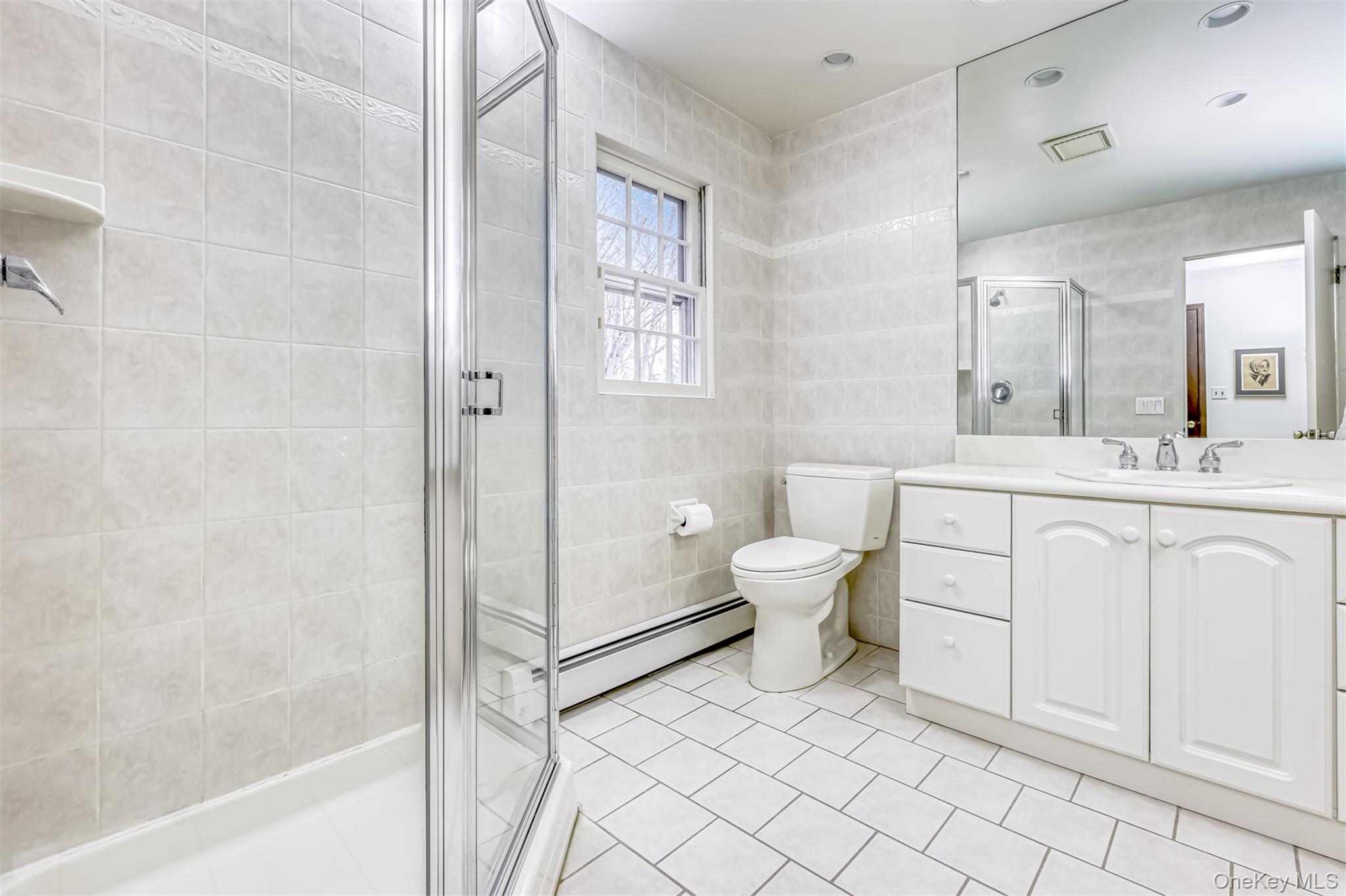 16 Kings Gate Road Suffern, NY 10901 - Photo 14 of 21 a spacious bathroom with a toilet sink and a mirror