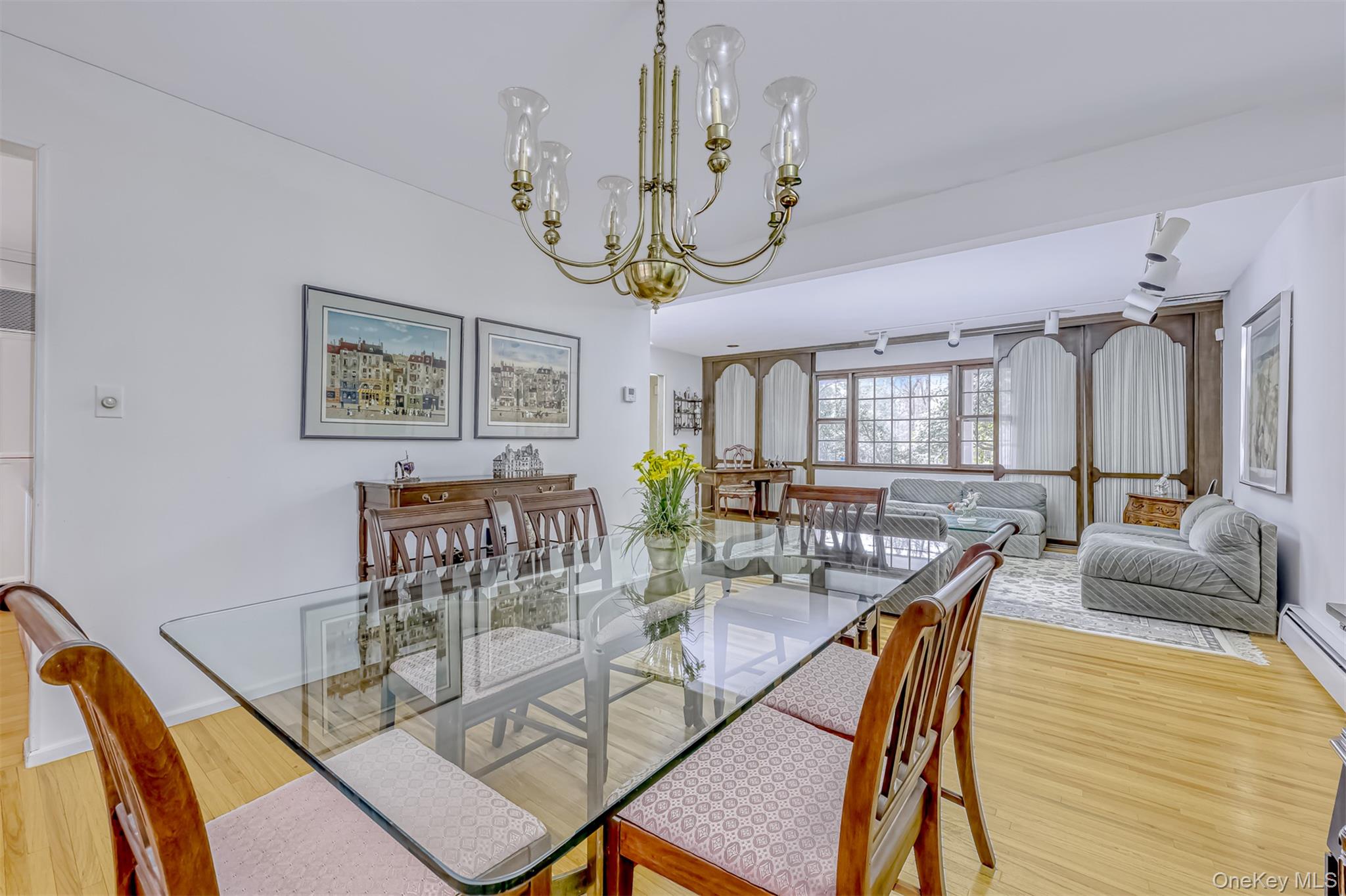 16 Kings Gate Road Suffern, NY 10901 - Photo 7 of 21 a view of a dining room with furniture a chandelier and wooden floor