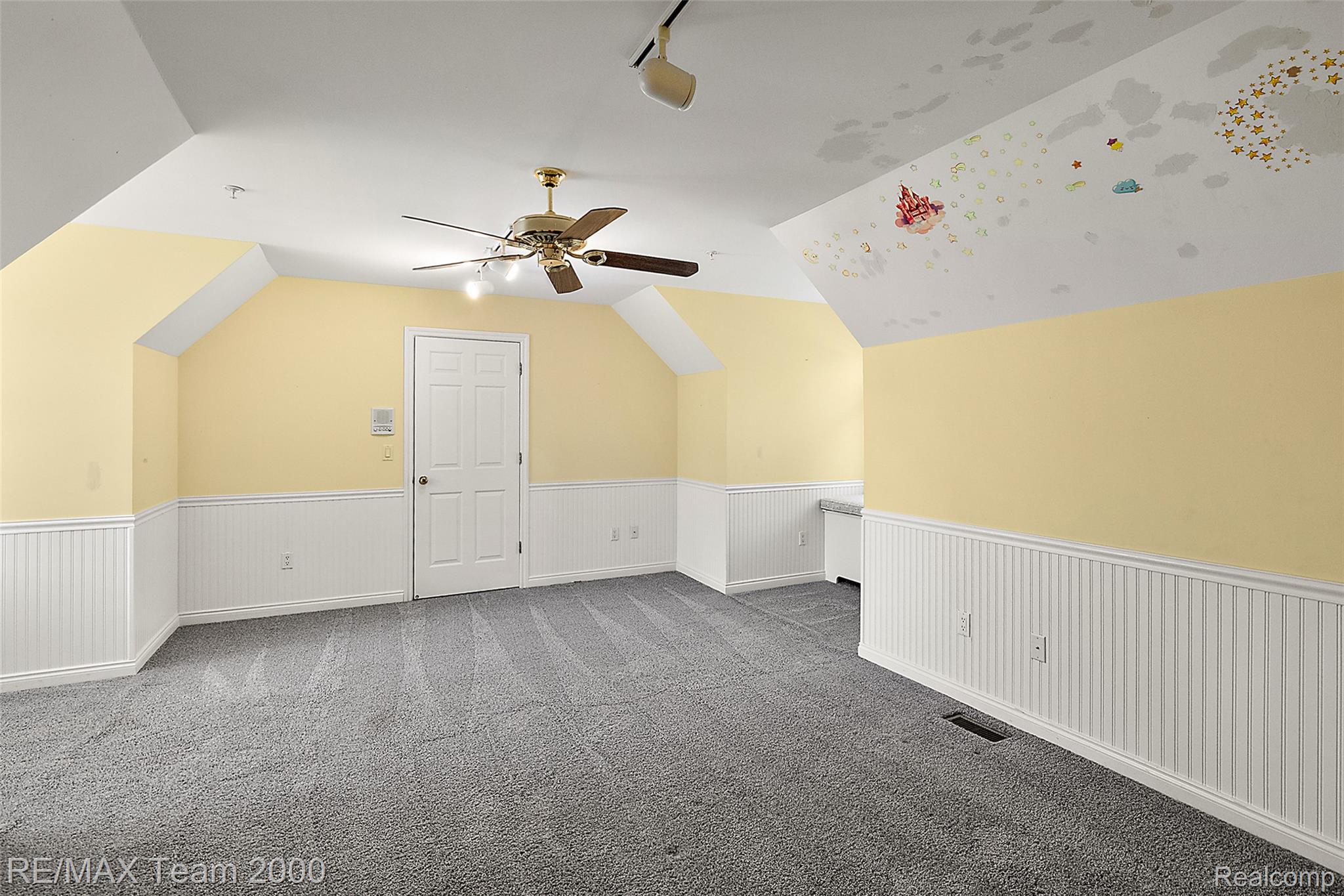 630 Sheldon Court Rochester, MI 48306 - Photo 64 of 94 Additional living space with lofted ceiling, ceiling fan, dark carpet, and a wainscoted wall