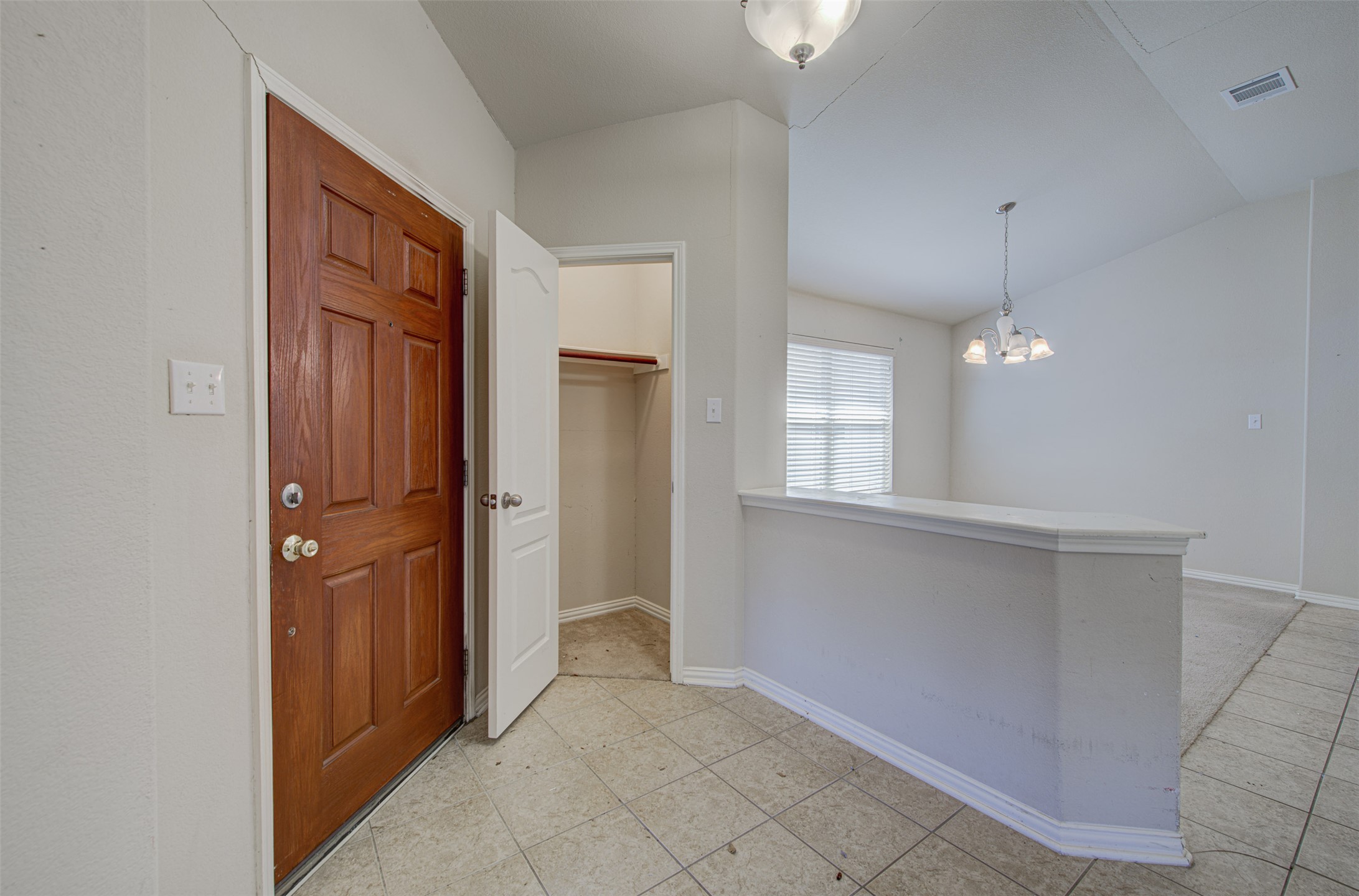 2090 Intrepid Drive Buda, TX 78610 - Photo 3 of 24 Entrance foyer with lofted ceiling and a chandelier
