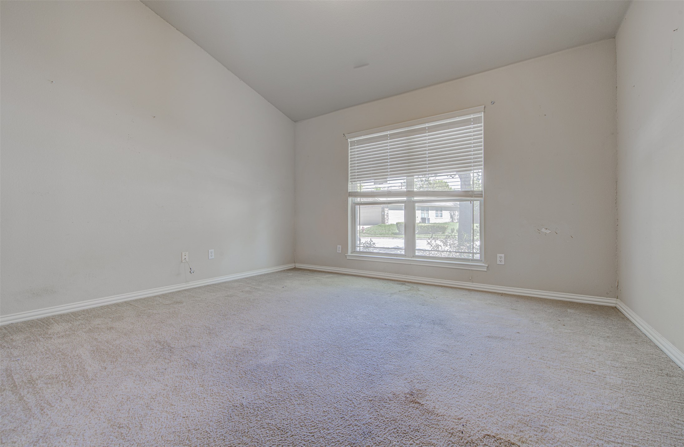 2090 Intrepid Drive Buda, TX 78610 - Photo 4 of 24 Empty room featuring light colored carpet and lofted ceiling