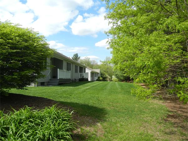 93 Stow Road, Unit 2 Boxborough, MA 01719 - Photo 4 of 14 a view of a house with backyard and garden