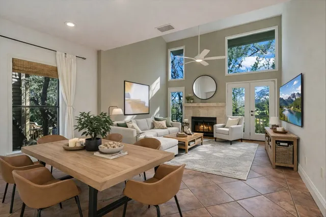a living room with furniture a fireplace and a potted plant
