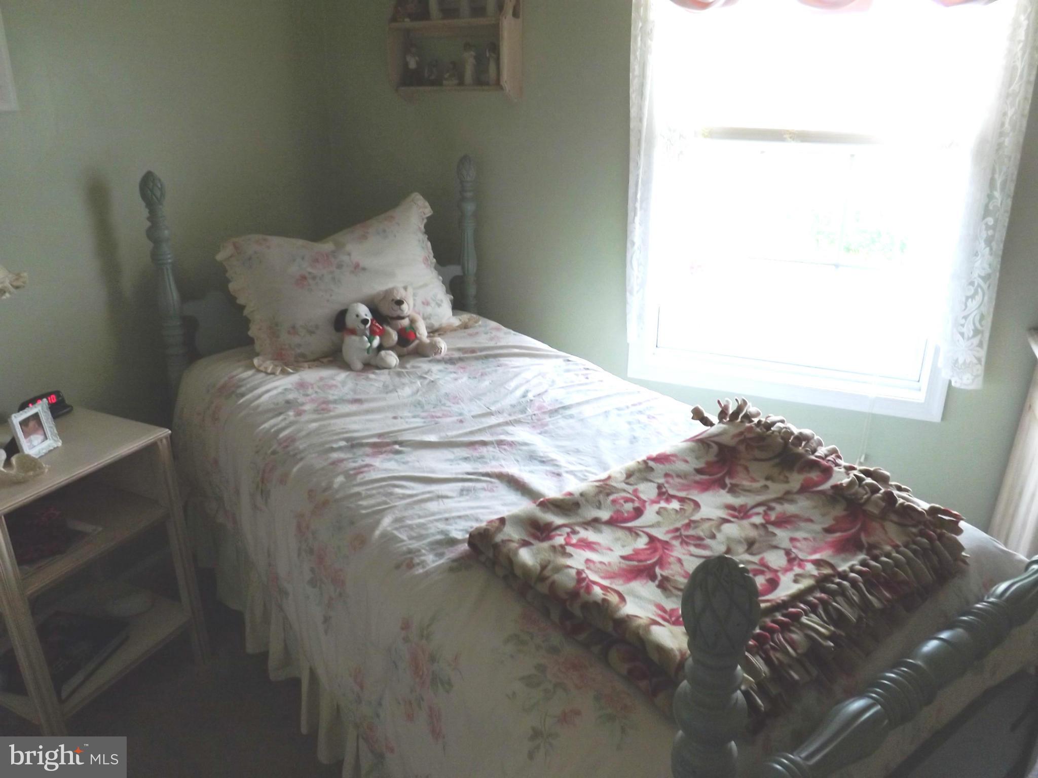 36 Roger Court Ranson, WV 25438 - Photo 13 of 29 a bed sitting in a bedroom next to a window