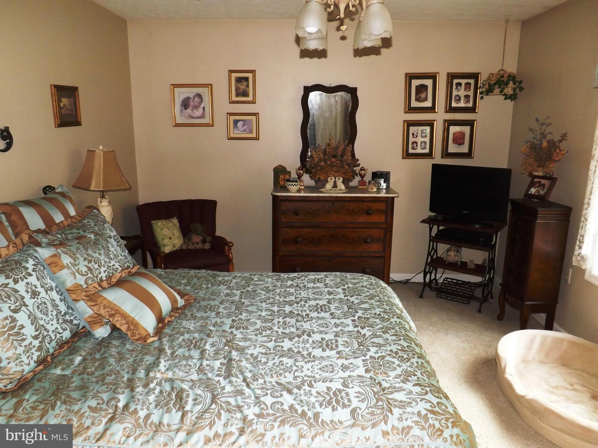 36 Roger Court Ranson, WV 25438 - Photo 15 of 29 a bedroom with a bed and wooden floor