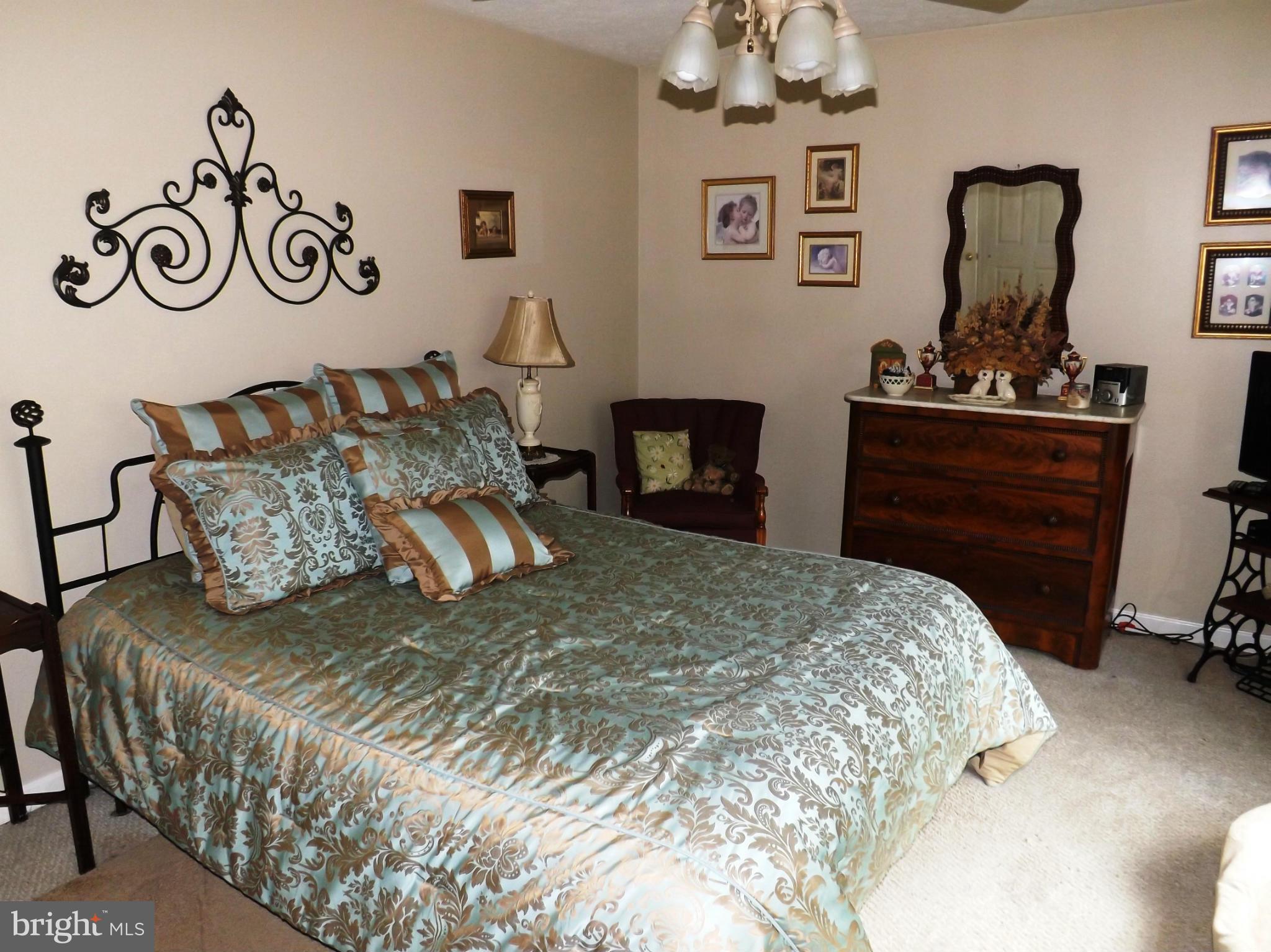 36 Roger Court Ranson, WV 25438 - Photo 16 of 29 a bedroom with a bed and a table