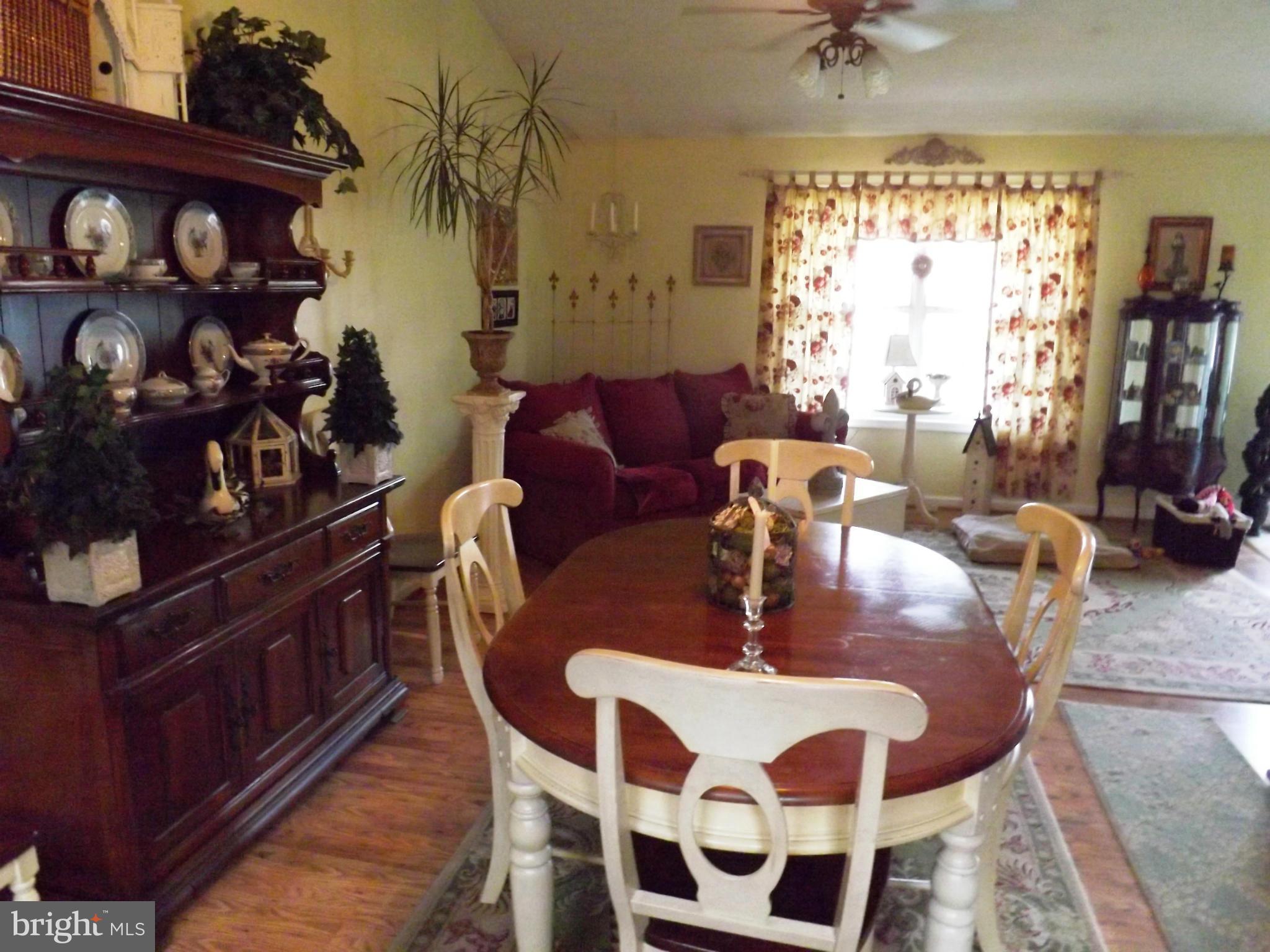 36 Roger Court Ranson, WV 25438 - Photo 3 of 29 a dining room with furniture a rug and wooden floor