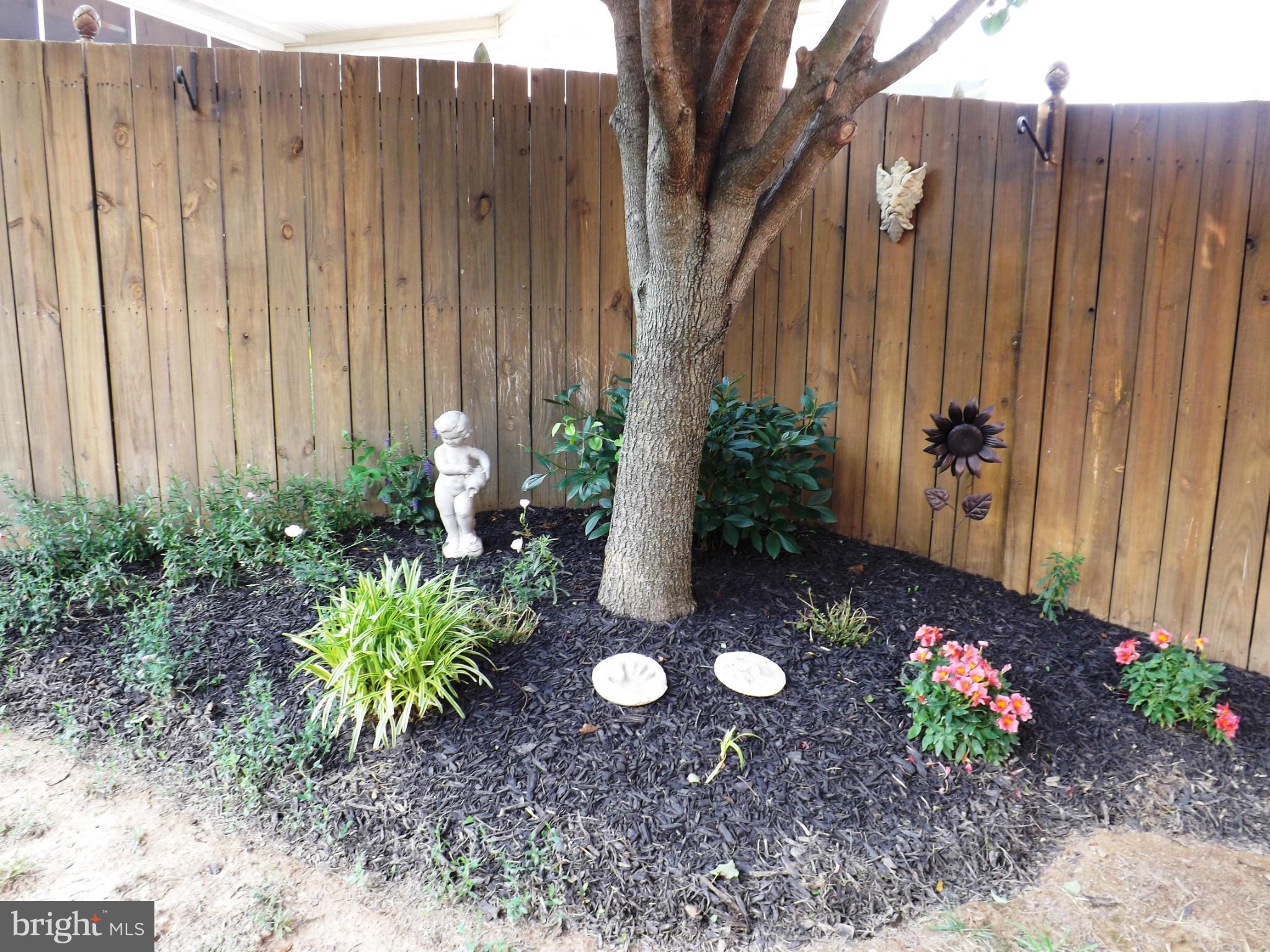 36 Roger Court Ranson, WV 25438 - Photo 24 of 29 a view of a backyard with plants and a potted plant