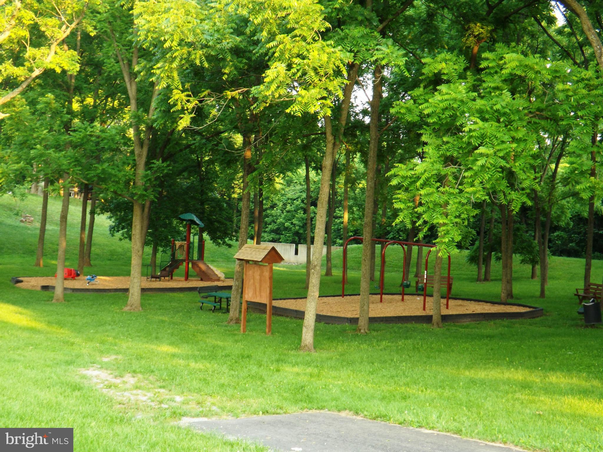 36 Roger Court Ranson, WV 25438 - Photo 28 of 29 a view of a park with lawn chairs and a slide