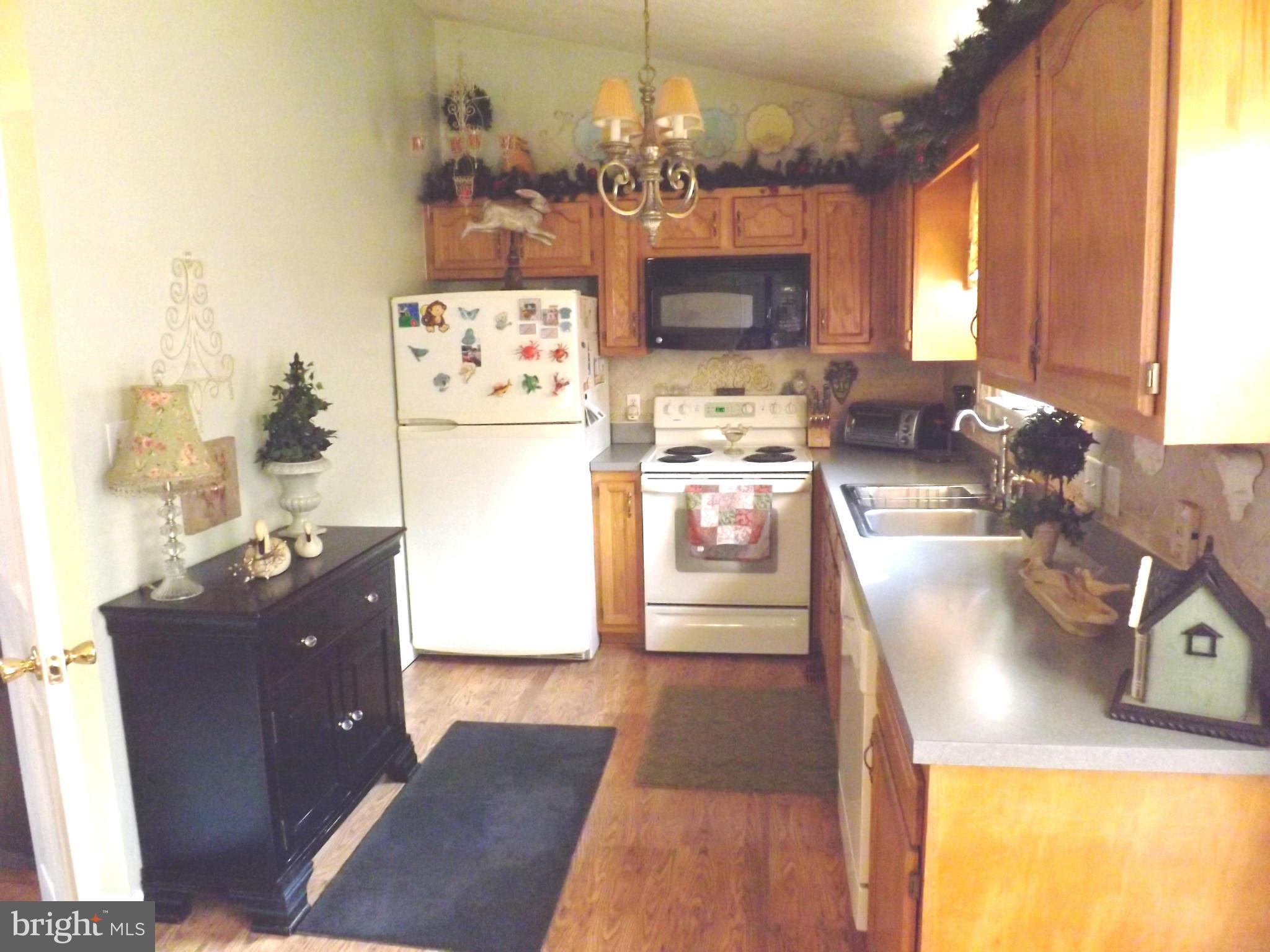 36 Roger Court Ranson, WV 25438 - Photo 4 of 29 a kitchen with a refrigerator and a stove