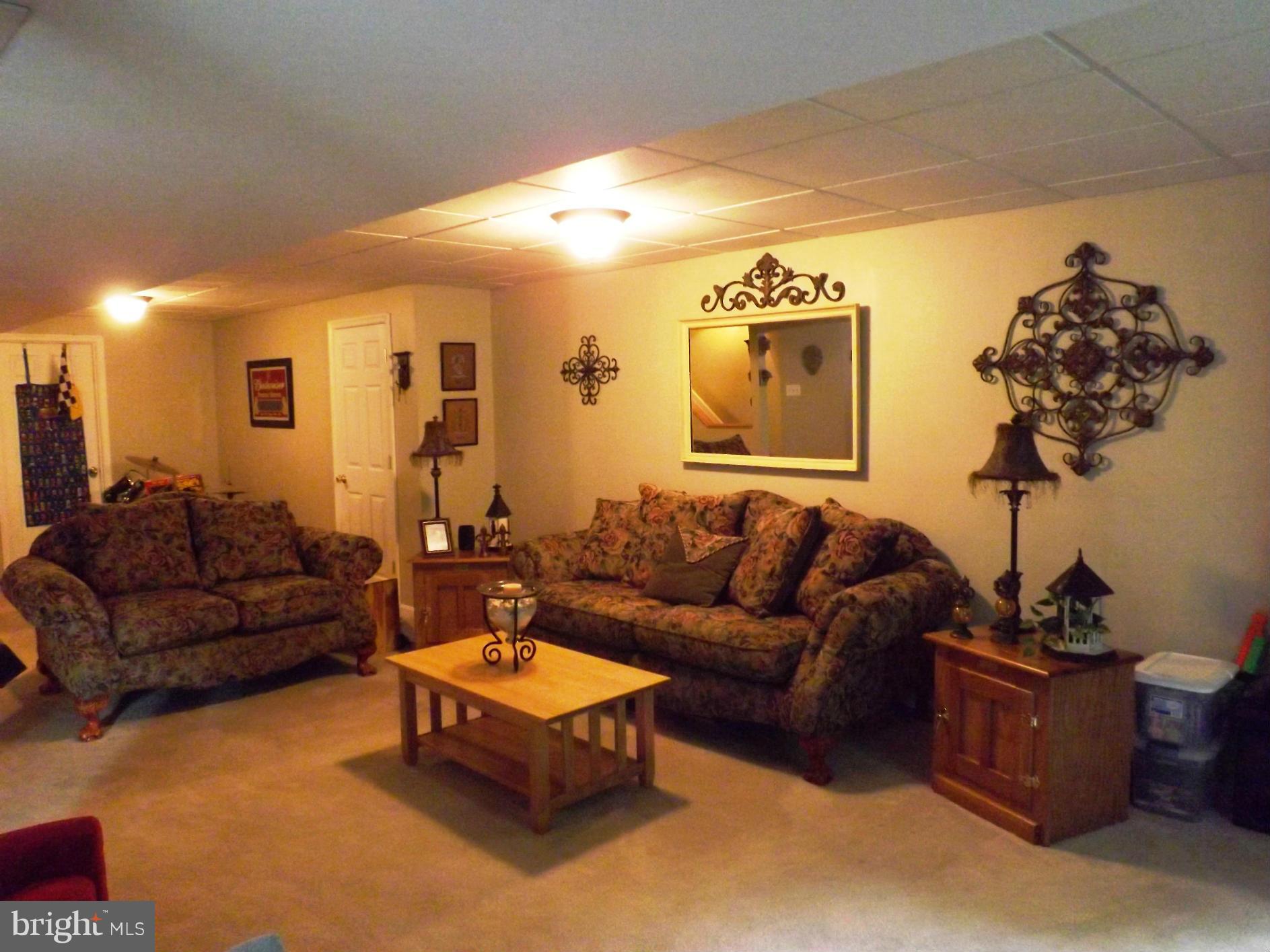 36 Roger Court Ranson, WV 25438 - Photo 8 of 29 a living room with furniture a couch and a potted plant