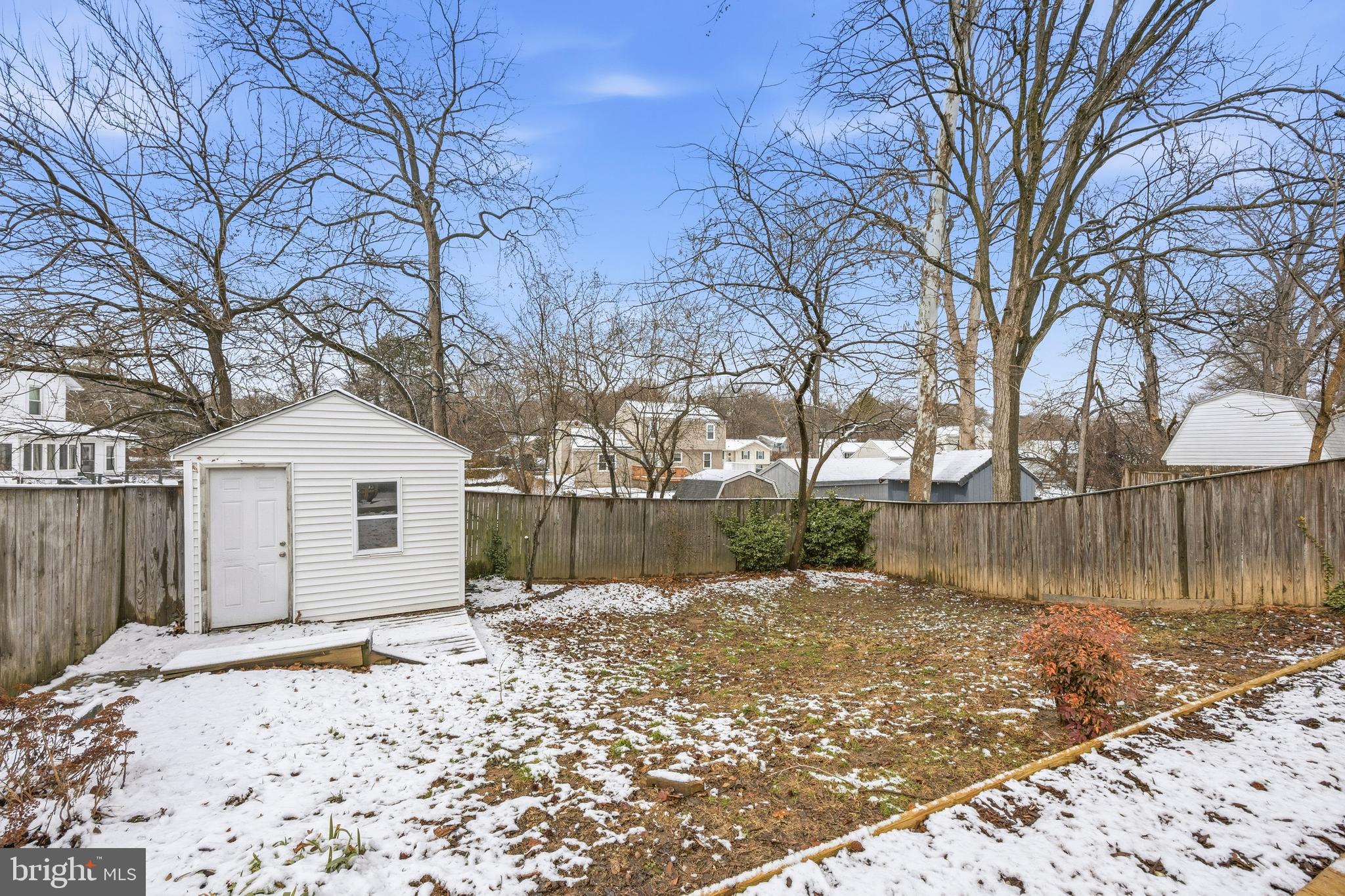 652 Chapelview Drive Odenton, MD 21113 - Photo 46 of 50 a front view of a house with a yard covered with snow