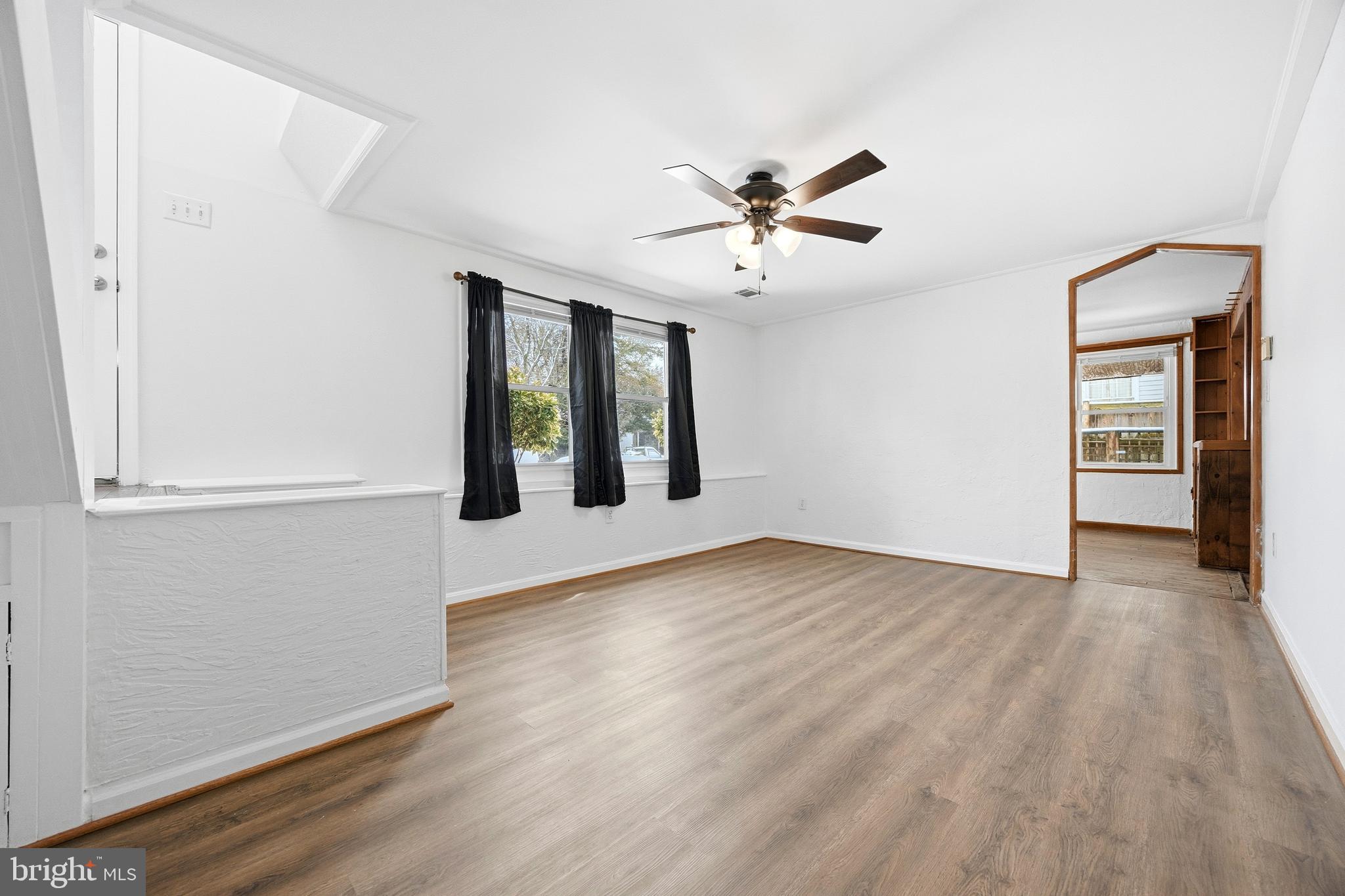 652 Chapelview Drive Odenton, MD 21113 - Photo 7 of 50 a view of an empty room with wooden floor and a window