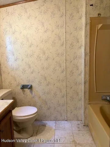 a bathroom with a toilet a sink and bathtub