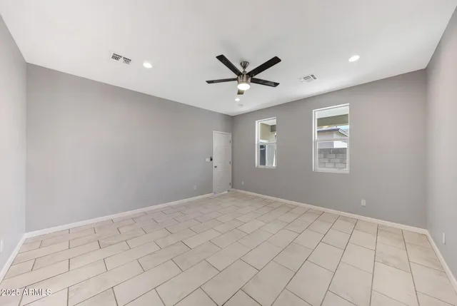 a large bathroom with a glass shower door and a sink
