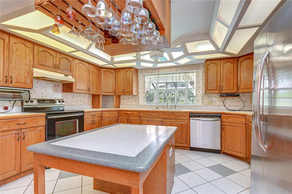 914 South Miller Road Valrico, FL 33594 - Photo 13 of 51 a kitchen with stainless steel appliances granite countertop a sink dishwasher stove and refrigerator