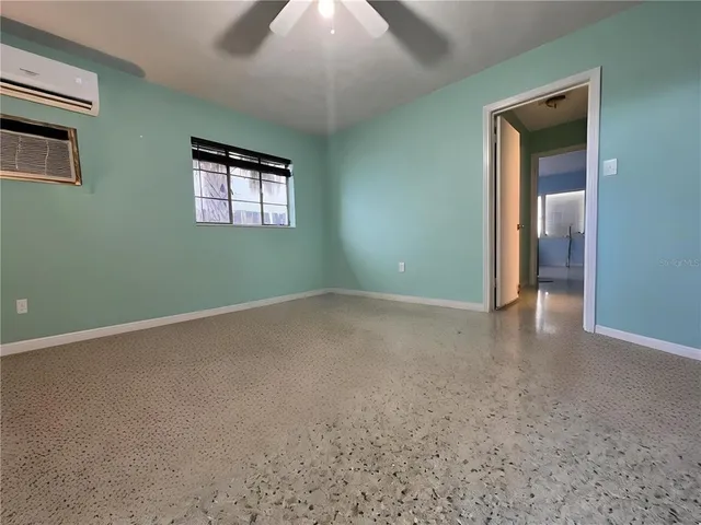 an empty room with windows and closet