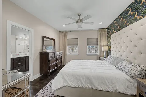 a spacious bedroom with a bed and a flat screen tv