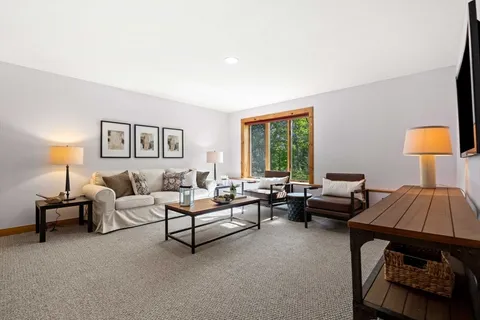a living room with furniture and a lamp